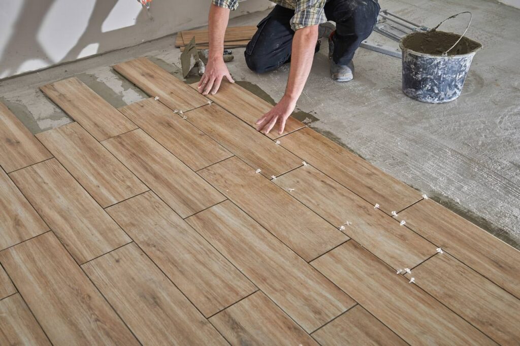 professional installing wood tile flooring